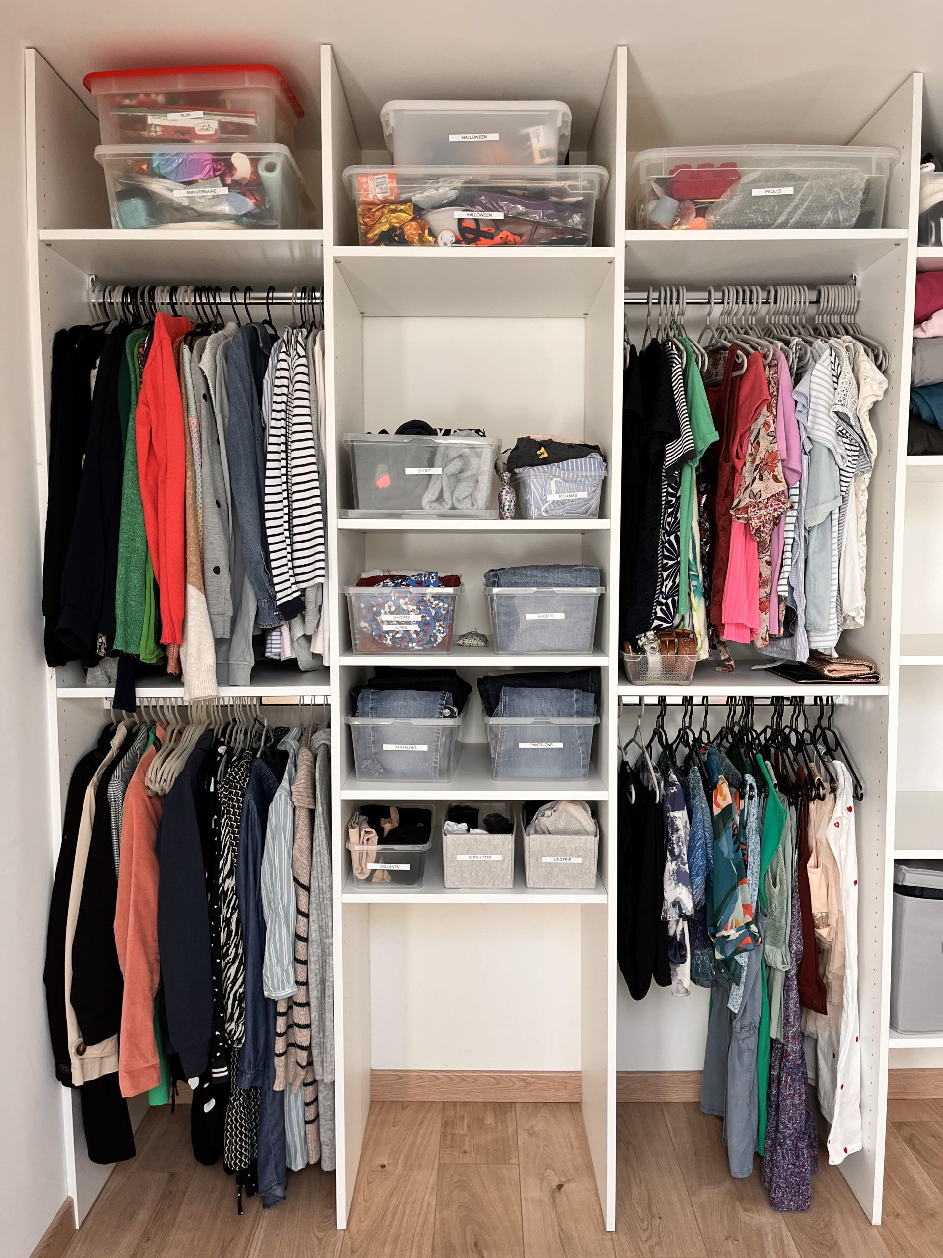 a closet with many clothes and baskets